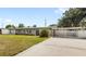 Well-maintained single-story home boasting a carport, green lawn, and refreshed exterior at 4604 S Shore Rd, Orlando, FL 32839