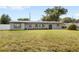 Charming single-story home featuring a stone facade, well-kept lawn, and freshly painted trim at 4604 S Shore Rd, Orlando, FL 32839