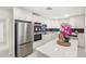 Elegant kitchen features stainless appliances, white cabinetry and countertops at 4604 S Shore Rd, Orlando, FL 32839