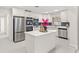 Bright and modern kitchen with stainless steel appliances, white cabinetry, and center island at 4604 S Shore Rd, Orlando, FL 32839