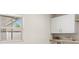 Bright laundry room with storage cabinets and a window that offers natural light and backyard views at 4604 S Shore Rd, Orlando, FL 32839