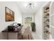 Bright office with a modern desk, open shelves, and a peaceful view of the outdoors at 4604 S Shore Rd, Orlando, FL 32839