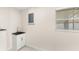 Bright utility room features a sink with a cabinet and a window for natural light at 4604 S Shore Rd, Orlando, FL 32839