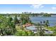 Scenic water view featuring the city skyline, lush trees, and residential homes on the water at 4604 S Shore Rd, Orlando, FL 32839