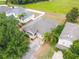 An aerial view of a single-Gathering home featuring a well-manicured lawn and mature trees in a residential neighborhood at 5126 Rishley Run Way, Mount Dora, FL 32757