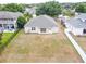 A view of the home's backyard with a well-maintained lawn, fencing, and the exterior facade at 5126 Rishley Run Way, Mount Dora, FL 32757