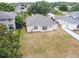 A view of the home's backyard, highlighting the yard space, fencing, and the exterior details at 5126 Rishley Run Way, Mount Dora, FL 32757