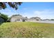 The expansive backyard features lush grass and a clear view of the home's back exterior at 5126 Rishley Run Way, Mount Dora, FL 32757