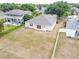 Backyard view showcasing the lawn area, fencing, and the home's rear exterior with sliding glass doors at 5126 Rishley Run Way, Mount Dora, FL 32757