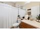 Bright bathroom featuring a shower with a curtain, a vanity and mirror, and tiled floors at 5126 Rishley Run Way, Mount Dora, FL 32757