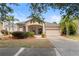 Charming single-story home featuring a manicured lawn and a two-car garage at 5126 Rishley Run Way, Mount Dora, FL 32757