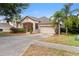Inviting single-story home with a covered entrance, two-car garage, and meticulous landscaping at 5126 Rishley Run Way, Mount Dora, FL 32757