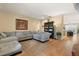 Open-concept living room featuring hardwood floors and a comfortable sectional sofa at 5126 Rishley Run Way, Mount Dora, FL 32757