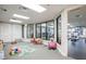 Bright playroom next to gym, with large windows and easy access to fitness equipment at 5126 Rishley Run Way, Mount Dora, FL 32757