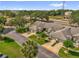 Aerial view of a well-maintained neighborhood with townhomes, landscaping, and close proximity to a main road at 543 Azinger Cir, Orlando, FL 32824