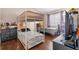 This bedroom features a cozy bunk bed, a separate single bed, and a dresser for storage, with wood laminate flooring at 543 Azinger Cir, Orlando, FL 32824