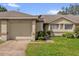 Charming single-story home featuring a one-car garage and well-maintained front lawn at 543 Azinger Cir, Orlando, FL 32824