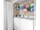 A dedicated laundry room with shelving that maximizes vertical space and helps keep cleaning supplies organized at 543 Azinger Cir, Orlando, FL 32824