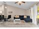 Spacious living room featuring tile flooring, a modern sofa, and natural light at 543 Azinger Cir, Orlando, FL 32824
