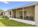 A screened patio featuring seating and access to the grassy backyard at 543 Azinger Cir, Orlando, FL 32824