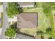 Aerial view of a home showcasing its well-maintained roof, surrounding landscaping, and neighborhood at 5839 Tarleton Way, Mount Dora, FL 32757