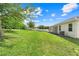 Well-maintained backyard with a lush lawn and a covered patio, ideal for relaxing and entertaining at 5839 Tarleton Way, Mount Dora, FL 32757