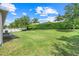 Spacious backyard featuring lush green grass and a privacy hedge, perfect for outdoor activities at 5839 Tarleton Way, Mount Dora, FL 32757