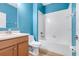 Bathroom featuring blue walls, a sink, and a bathtub and shower combo at 5839 Tarleton Way, Mount Dora, FL 32757