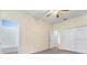 Spacious bedroom with neutral carpet, and access to the bathroom with a tub at 5839 Tarleton Way, Mount Dora, FL 32757