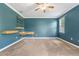 Bedroom featuring carpeted floors, a window, and custom shelving at 5839 Tarleton Way, Mount Dora, FL 32757