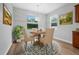 Charming dining area with a round table, chandelier, and view of the backyard at 5839 Tarleton Way, Mount Dora, FL 32757