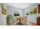 Charming dining area featuring a round wooden table, comfortable seating, and bright natural light at 5839 Tarleton Way, Mount Dora, FL 32757