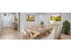 Elegant dining room with a long wooden table, seating for six, and modern decor at 5839 Tarleton Way, Mount Dora, FL 32757