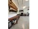Spacious garage featuring workbench, shelving, speckled floors, and ample storage at 5839 Tarleton Way, Mount Dora, FL 32757