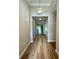 Well-lit hallway with wood flooring, leading to the main living areas at 5839 Tarleton Way, Mount Dora, FL 32757