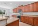 Modern kitchen features stainless steel appliances, granite countertops, and wood cabinetry at 5839 Tarleton Way, Mount Dora, FL 32757