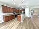 Spacious kitchen featuring stainless steel appliances, granite countertops, and a kitchen island at 5839 Tarleton Way, Mount Dora, FL 32757