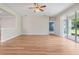 Bright living room with wood flooring and sliding glass doors to outdoor area at 5839 Tarleton Way, Mount Dora, FL 32757