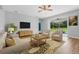 Cozy living room with a comfortable sofa, chairs, and sliding glass doors to the patio at 5839 Tarleton Way, Mount Dora, FL 32757