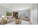 Cozy living room featuring a comfortable sofa, armchairs, a bookshelf, and a decorative rug at 5839 Tarleton Way, Mount Dora, FL 32757
