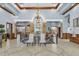Elegant lobby with detailed tile flooring, ornate chandeliers, and staircase with decorative metal railings at 5839 Tarleton Way, Mount Dora, FL 32757