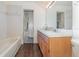 Bathroom with double sink vanity, tiled floors and access to the shower at 6019 Long Peak Dr, Orlando, FL 32810