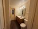 Modern bathroom with dual sinks, wood-look flooring, and ample lighting at 6019 Long Peak Dr, Orlando, FL 32810