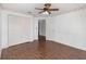 Bedroom showcasing wood-look floors, decorative border, and double closets at 6019 Long Peak Dr, Orlando, FL 32810
