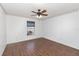 Bedroom featuring wood-look floors, decorative border, and view of the backyard at 6019 Long Peak Dr, Orlando, FL 32810