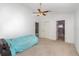 Bedroom with neutral carpet, ceiling fan, large window, and access to an ensuite bathroom at 6019 Long Peak Dr, Orlando, FL 32810
