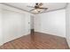 Bedroom featuring wood-look flooring, decorative border, and spacious closet at 6019 Long Peak Dr, Orlando, FL 32810