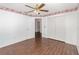 Bedroom featuring wood-look floors, decorative border, closet, and doorways at 6019 Long Peak Dr, Orlando, FL 32810