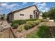 View of home's side and front showing manicured hedges and mulched garden bed at 6019 Long Peak Dr, Orlando, FL 32810
