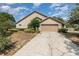 Attractive single-Gathering home with a well-maintained lawn and a two-car garage at 6019 Long Peak Dr, Orlando, FL 32810